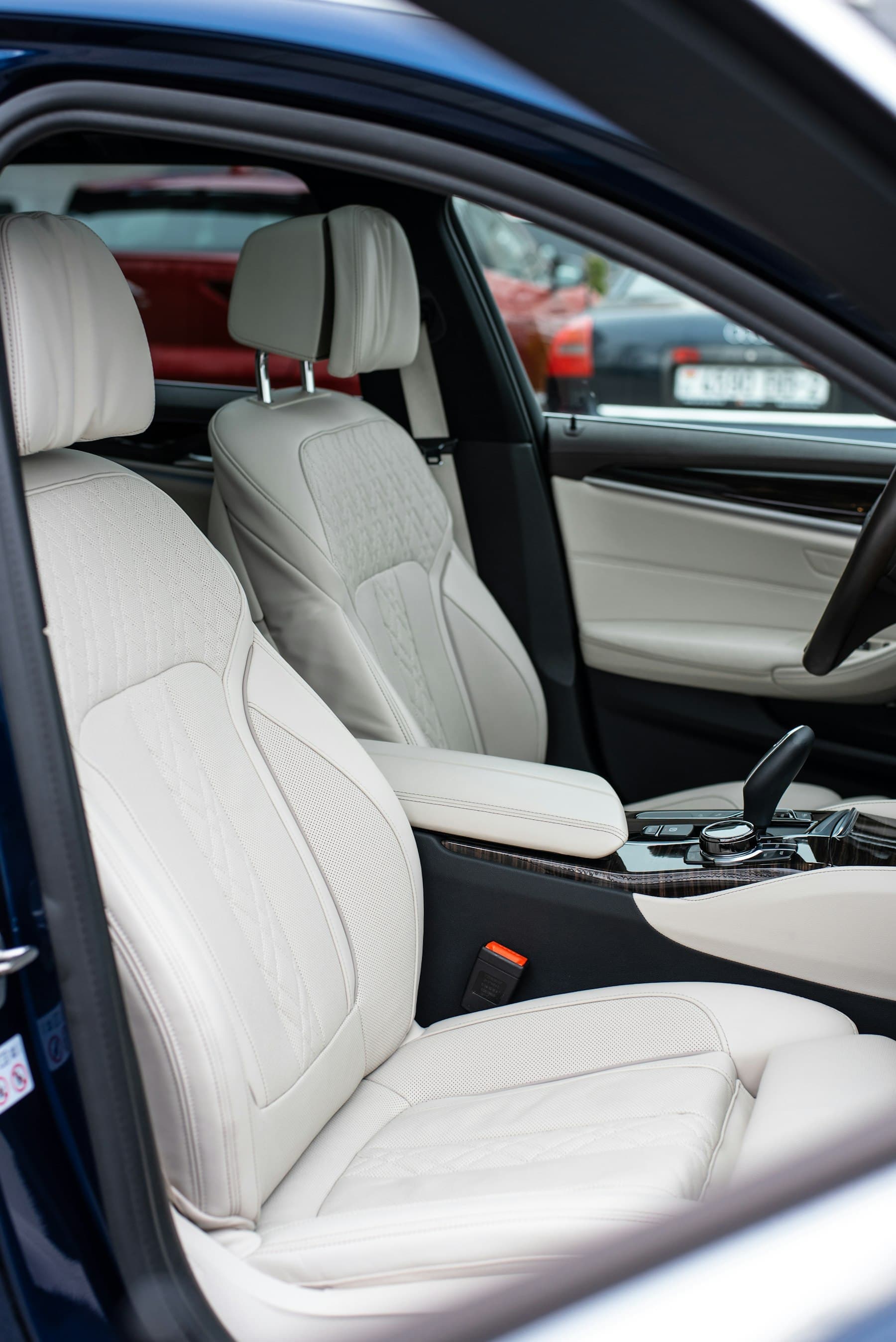 Light grey leather front seats and centre console of a car